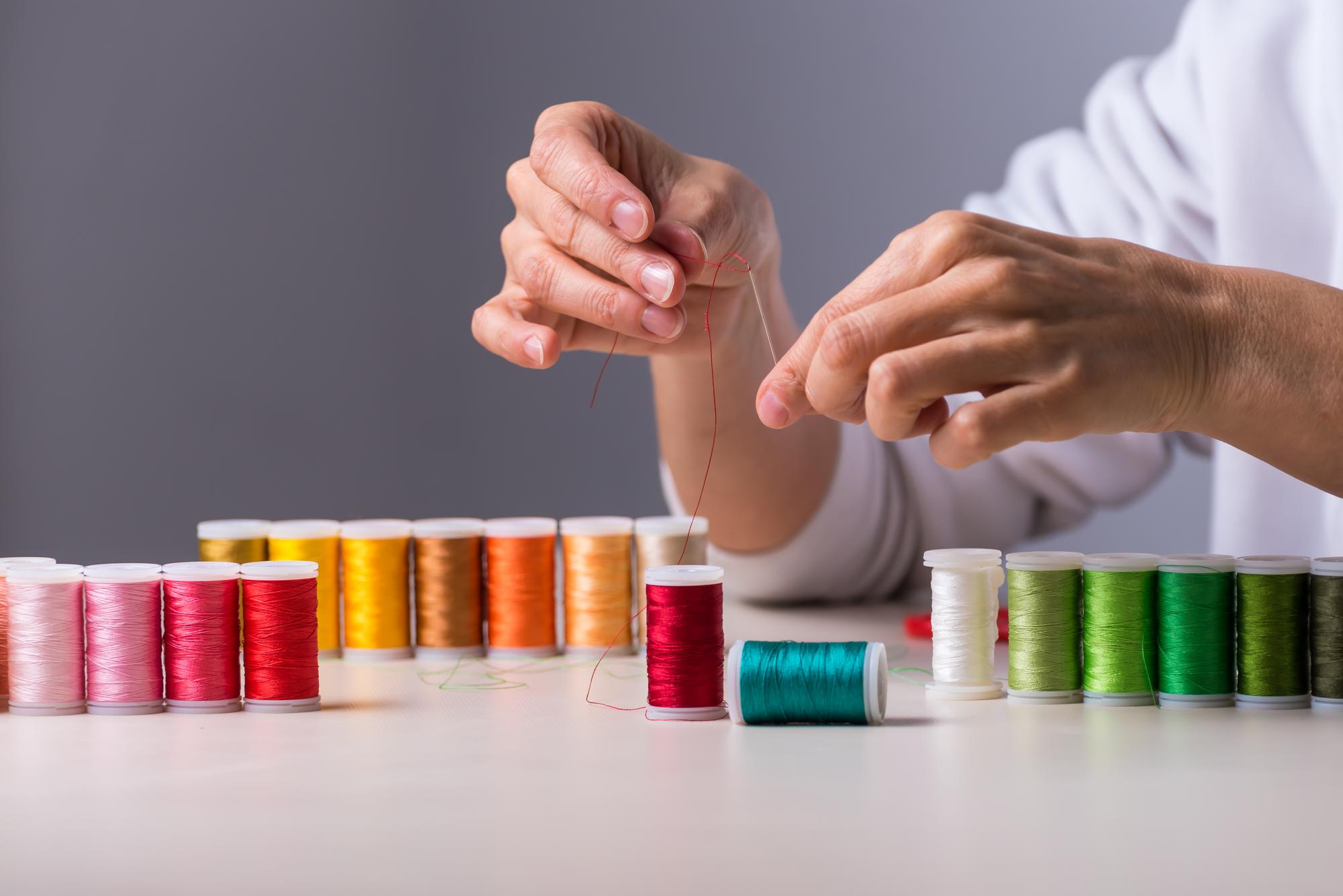 Studio assistant selecting threads